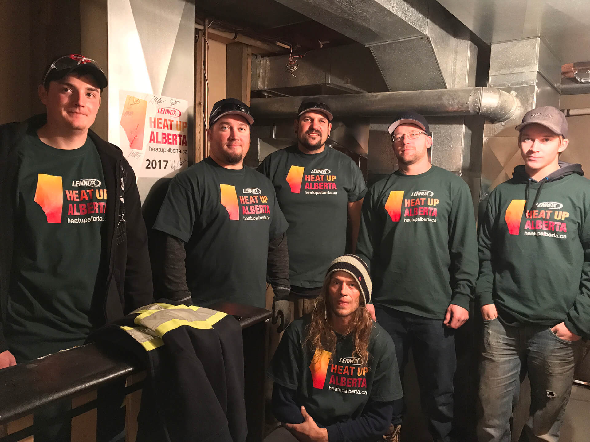 Volunteers in front of newly installed furnace